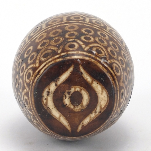 476 - Tibetan stained temple stone having a geometric design, 13.5cm high