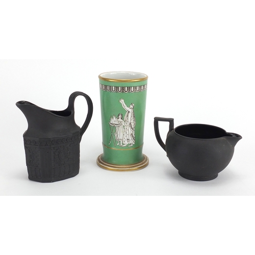 520 - Two Victorian basalt milk jugs and a pottery spill vase decorated with a winged angel, the largest 1... 