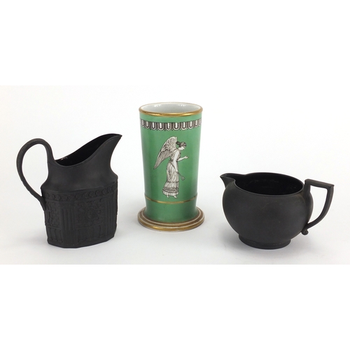 520 - Two Victorian basalt milk jugs and a pottery spill vase decorated with a winged angel, the largest 1... 