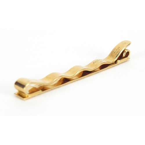 714 - 18ct gold Cartier tie slide, numbered L8766, 6cm in length, approximate weight 9.0g