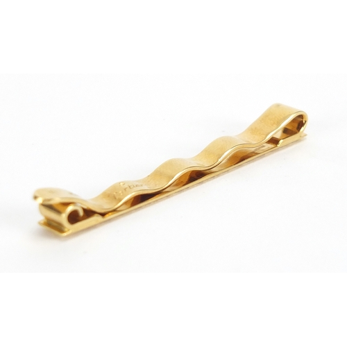 714 - 18ct gold Cartier tie slide, numbered L8766, 6cm in length, approximate weight 9.0g