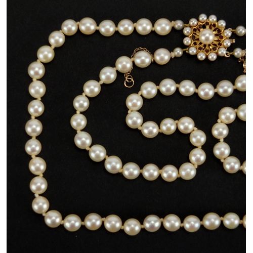 737 - Two row pearl necklace with 9ct gold and garnet clasp, 40cm in length, approximte weight 54.8g