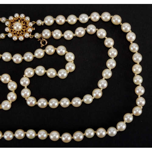 737 - Two row pearl necklace with 9ct gold and garnet clasp, 40cm in length, approximte weight 54.8g