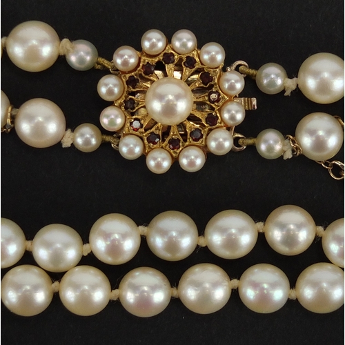 737 - Two row pearl necklace with 9ct gold and garnet clasp, 40cm in length, approximte weight 54.8g