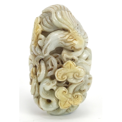 429 - Chinese white jade touch stone carved with a bird of Paradise and a bat, 8.5cm high