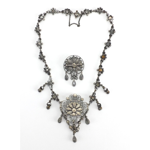 679 - 800 grade silver suffragette necklace and brooch set with pink and green stones, housed in a Hamilto... 