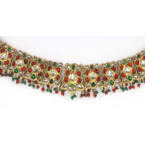 481 - Indian? gilt metal necklace set with clear red and green stones, 22.5cm wide