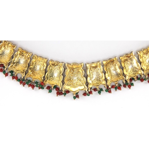 481 - Indian? gilt metal necklace set with clear red and green stones, 22.5cm wide