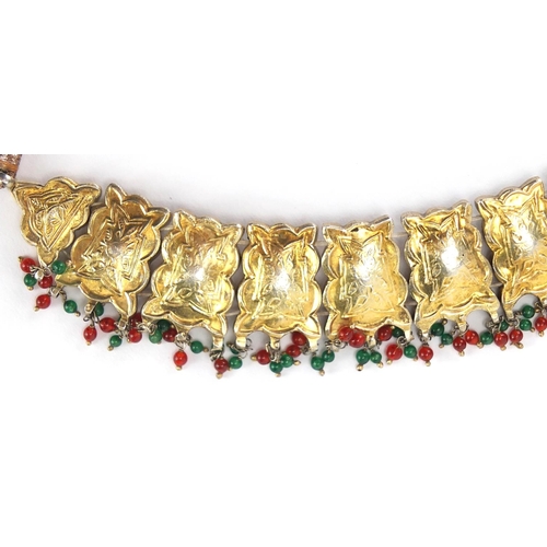 481 - Indian? gilt metal necklace set with clear red and green stones, 22.5cm wide