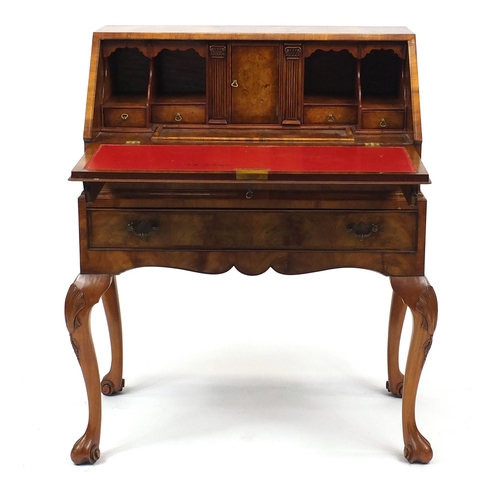 2014 - Mahogany bureau with feather banded fall, enclosing a fitted interior, above two drawers on cabriole... 