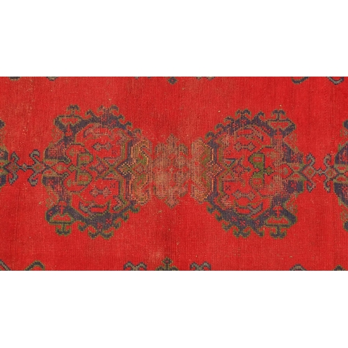 2030 - Rectangular Turkish Oushak rug, having a stylised floral design onto a red ground, 215cm x 178cm