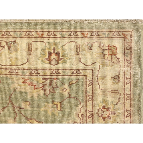2048 - Rectangular Persian Zeigler rug, having a scrolling vine and flower head design, 157cm x 80cm