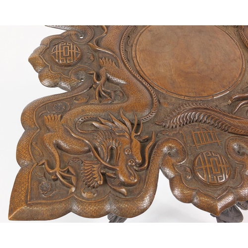 2049 - Chinese hardwood table, the square top deeply carved with two dragons, bats and symbols, 59cm H x 61... 