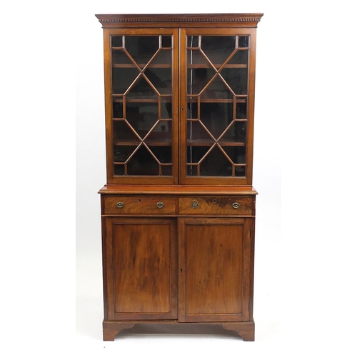 29 - Mahogany bookcase fitted with a pair of glazed doors, enclosing two adjustable shelves above two dra... 