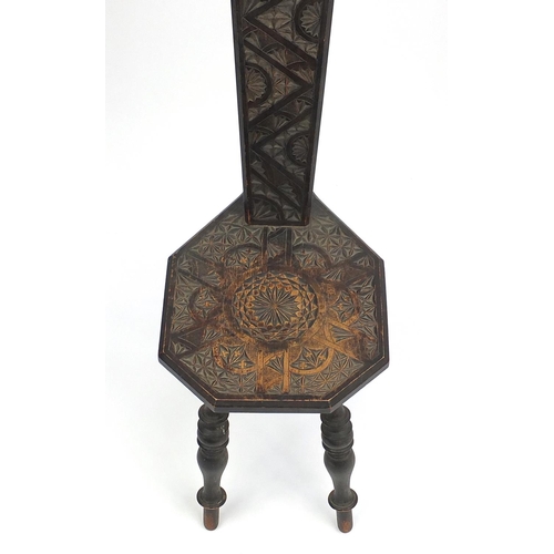 145 - Victorian carved oak three legged chair