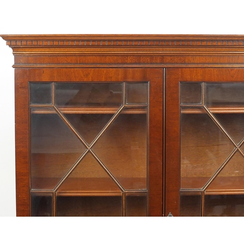 66 - Mahogany bookcase fitted with a pair of glazed doors, above a pair of drawers and cupboard doors, 18... 