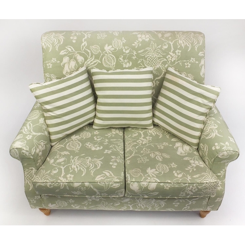 63 - Two seater settee and armchair with green fruit upholstery