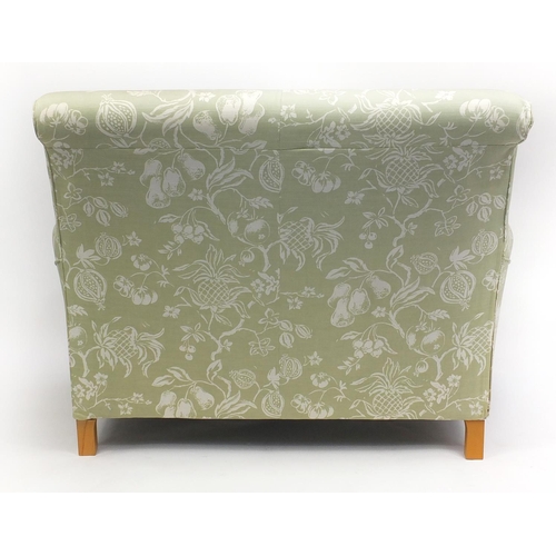 63 - Two seater settee and armchair with green fruit upholstery