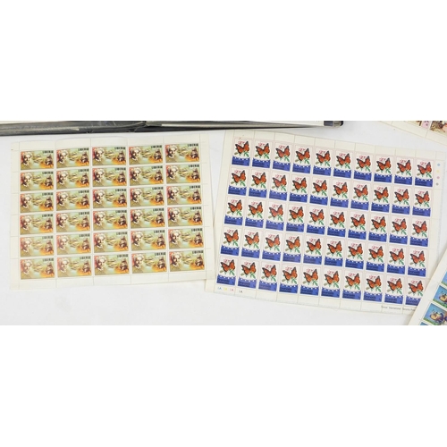 717 - First day covers arranged in three albums and a selection of stamp sheets