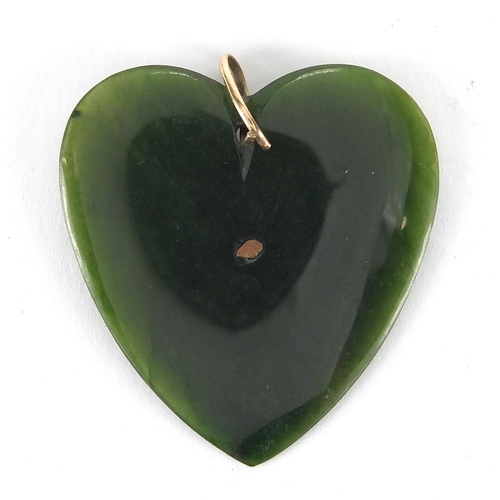 357 - Chinese green jadeite love heart pendant with gold coloured metal mounts, 4.5cm in length, approxima... 