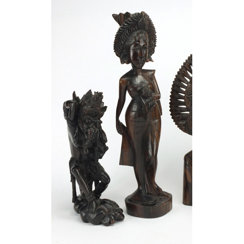 250 - Six Balinese hardwood carvings including a nude female, the largest 39cm high