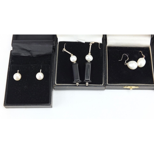 527 - Ten pairs of silver and pearl earrings, with fitted boxes