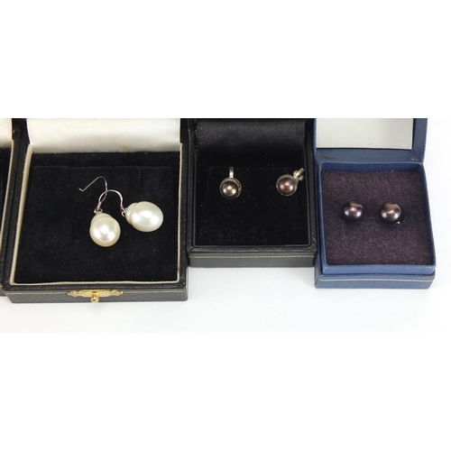 527 - Ten pairs of silver and pearl earrings, with fitted boxes