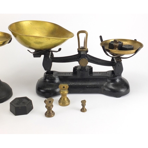 498 - Two sets of cast iron scales with brass pans and weights, including Libra