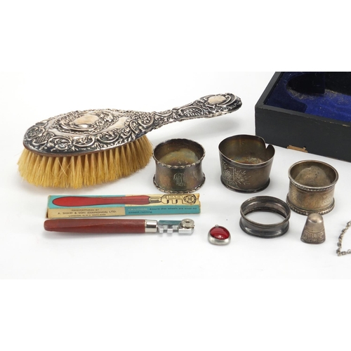 531 - Silver items including napkin rings, silver backed brush, necklace and a thimble