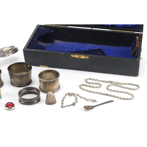 531 - Silver items including napkin rings, silver backed brush, necklace and a thimble