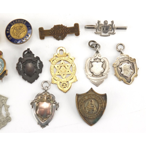 549 - Military and sporting jewels including silver examples