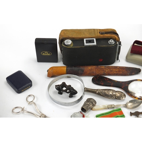 564 - Box of objects including a vintage camera, silver plated items, olivewood book and coins