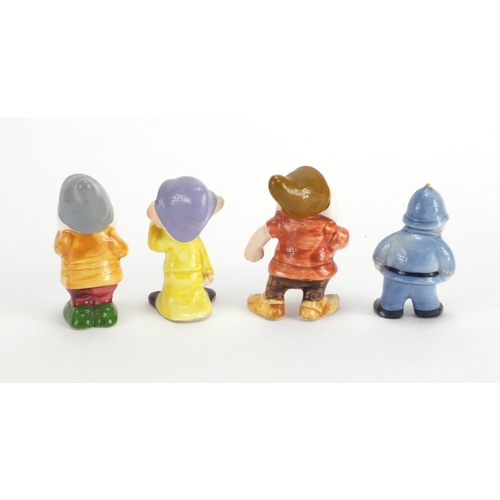 517 - Three porcelain Snow White and the Seven Dwarf figures and a Noddy's PC Plodd figure, the largest 7c... 