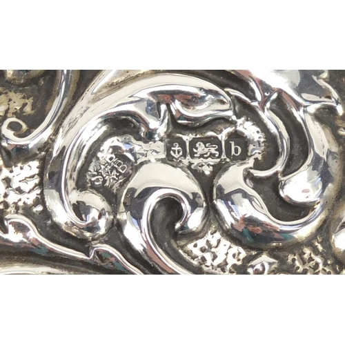 536 - Victorian silver back hand mirror profusely embossed with birds amongst flowers, Birmingham hallmark... 