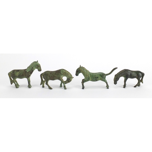 559 - Four archaic style cast metal horses, the largest 10.5cm in length