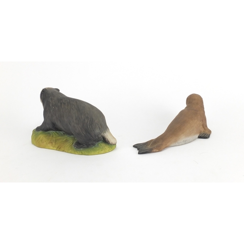 433 - Two Aynsley animals of a badger and a seal, the largest 18cm in length