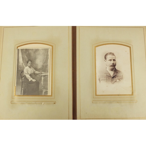 727 - Two Victorian photograph albums, with a selection of photographs and cabinet cards