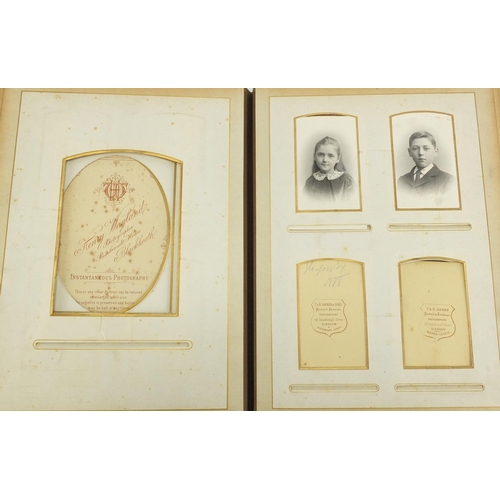 727 - Two Victorian photograph albums, with a selection of photographs and cabinet cards