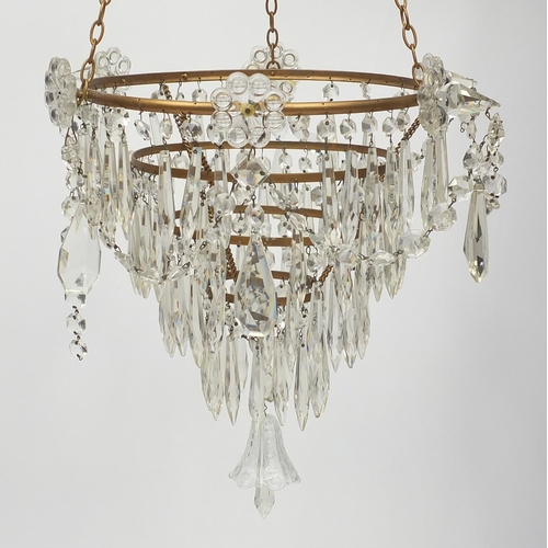 176 - Brass four tier chandelier with glass drops, 82cm high x 28cm in diameter