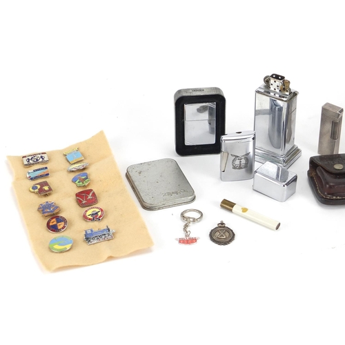 552 - Bag of objects including lighters, enamelled Butlins badges and a silver sports jewel