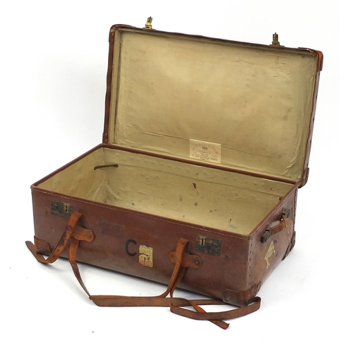 12 - Vintage leather suitcase with brass locks, with shipping labels, 85cm wide