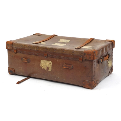 12 - Vintage leather suitcase with brass locks, with shipping labels, 85cm wide