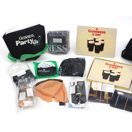 303 - Group of Guinness advertising items including hats and wigs