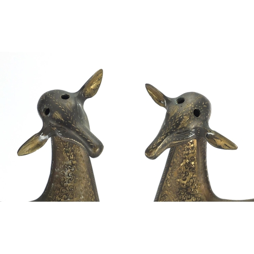 568 - Pair of stylised brass deer's, engraved with flower heads and foliage, each 50cm high