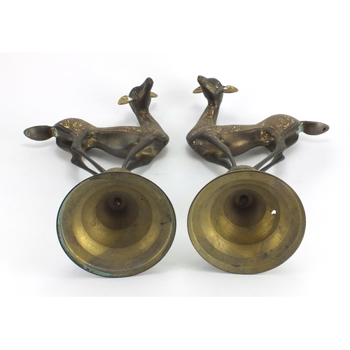 568 - Pair of stylised brass deer's, engraved with flower heads and foliage, each 50cm high