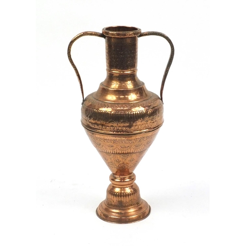 677 - Large Eastern copper urn vase with twin handles, engraved with stylised motifs, 66cm high