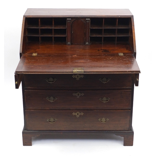 2061 - Georgian walnut bureau, the fall enclosing a fitted interior above four graduated drawers, raised on... 