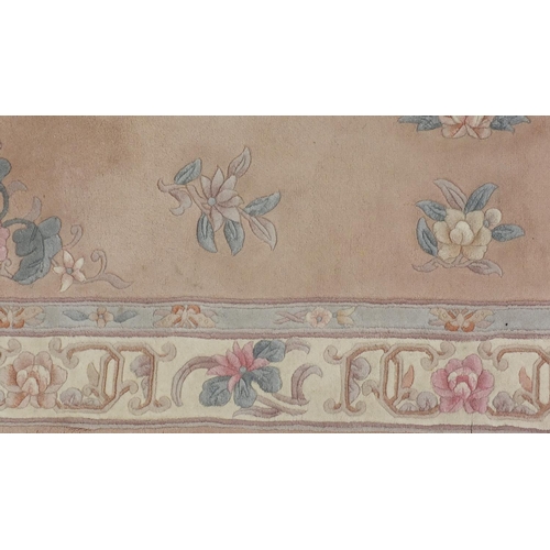 34 - Peach ground Chinese rug, with floral border, approximately 250cm x 155cm