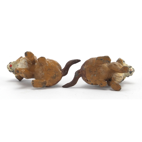 516A - Two hand painted metal figures of seated dogs, 6cm in length