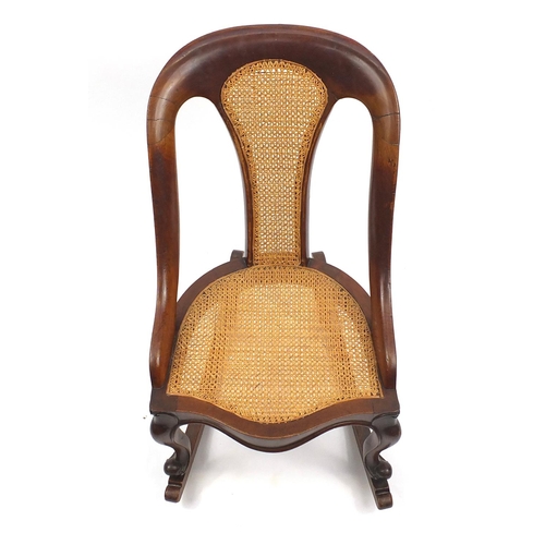 109 - Mahogany framed rocking chair with cane back and seat, 80cm high